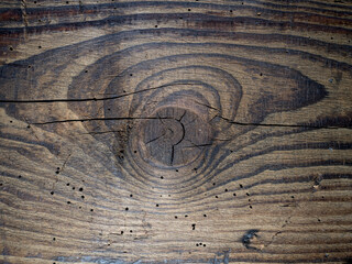Fototapeta premium A centuries-old timber with cracks and damage.