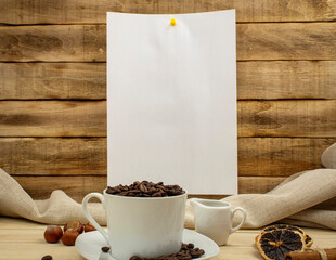 Fototapeta na wymiar Cup with coffee beans as background with place for text