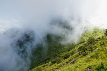 Mist running down a sunny hill in the mountain