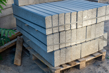 Pallet with concrete curbs for sidewalk construction