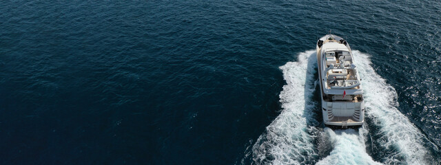 Aerial drone ultra wide photo of yacht sailing in deep blue open ocean sea