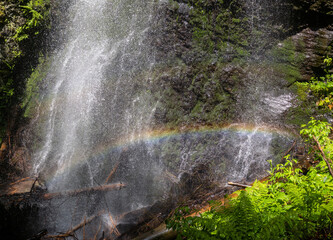 Picturesque summer Yalyn waterfall, higest waterfall in Ukrainian Carpathian Mountains, Marmaros. Beatiful rainbow in water streams and water dust.
