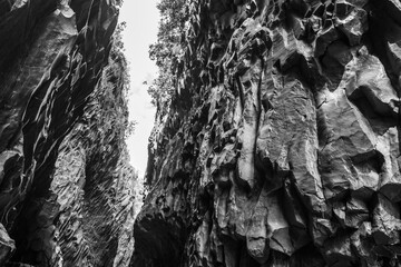 Fototapeta na wymiar Basalt rocks and pristine water of Alcantara gorges in Sicily, Italy
