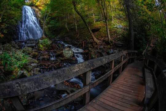A trail bridge crosses over the flow of Crabtree Falls on the Blue Ridge Parkway just north of Asheville, North Carolina
