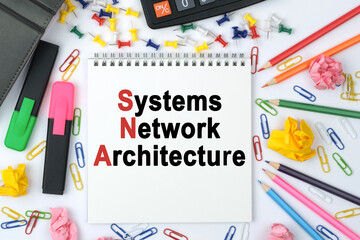On the table is a calculator, diary, markers, pencils and a notebook with the inscription - Systems Network Architecture