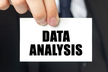 Businessman shows a card with the text - DATA ANALYSIS