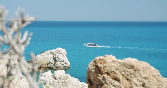 Daily trip boat in turquoise colored sea near Agios Nikitas, Lefkada, Ionian Islands, Greece.