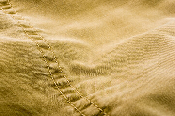 clothing items stonewashed cotton fabric texture with seams, clasps, buttons and rivets, macro