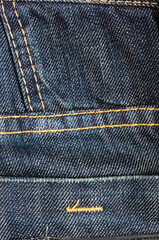clothing items blue stonewashed faded jeans cotton fabric texture with seams, clasps, buttons and...