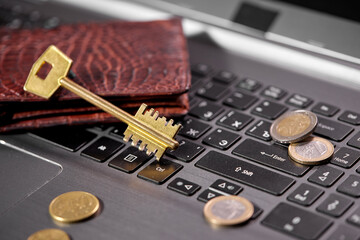 money coins on laptop computer