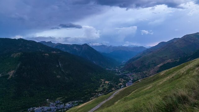 Beautiful valley with small typical mountain villages at background. Time Lapse video of panoramic view at sunset of Valle de Aran, Baqueira, Salard&uacute;, L&eacute;rida, Catalonia, Spain.