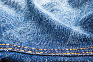 clothing items blue stonewashed faded jeans cotton fabric texture with seams, clasps, buttons and...