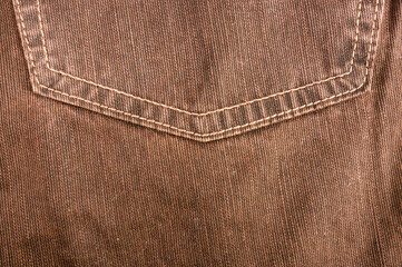 clothing items stonewashed cotton fabric texture with seams, clasps, buttons and rivets, macro