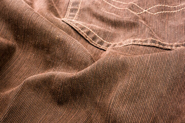 clothing items stonewashed cotton fabric texture with seams, clasps, buttons and rivets, macro