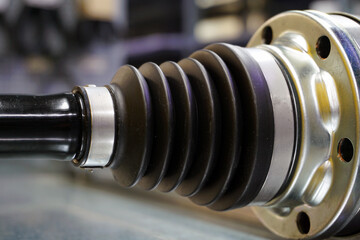 A protective boot mounted on the wheel drive of a modern car.  