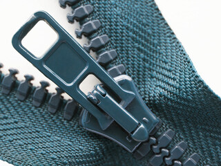 Blue zipper very close-up on a white background. Not isolated. Sewing production, home handicrafts,...