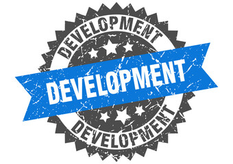 development stamp. grunge round sign with ribbon