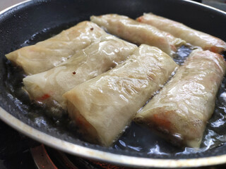 Popiah or spring rolls are cooked using hot cooking oil and presented to eat.. It comes with a variety of filling.  