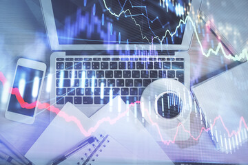 Stock market chart and top view computer on the table background. Double exposure. Concept of financial analysis.