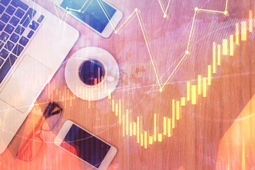 Double exposure of forex chart hologram over desktop with phone. Top view. Mobile trade platform concept.