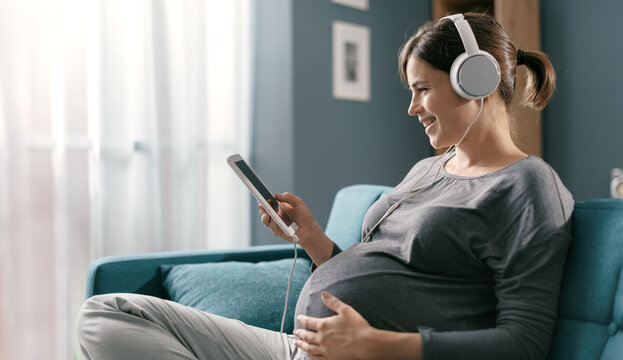Pregnant woman watching videos on a tablet