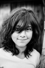 Close-up portrait of teen girl outdoor. Black and white photography.