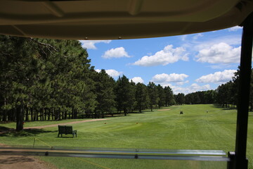 Fototapeta premium A view onto the fairway at the golf course on a beautiful summer day.