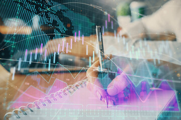 Double exposure of forex chart drawing over people taking notes background. Concept of financial analysis