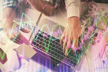 Double exposure of man and woman working together and forex graph hologram drawing. Financial analysis concept. Computer background. Top View.