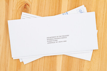 Business envelope addresses to IRS on a wood desk