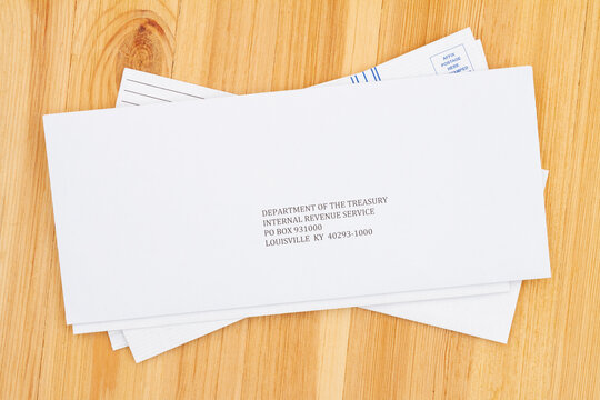 Business Envelope Addresses To IRS On A Wood Desk