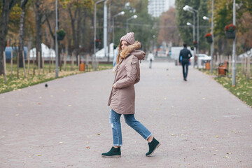 Young pretty woman walking in the autumn park