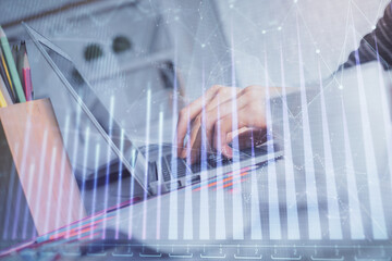 Double exposure of woman hands typing on computer and forex chart hologram drawing. Stock market invest concept.