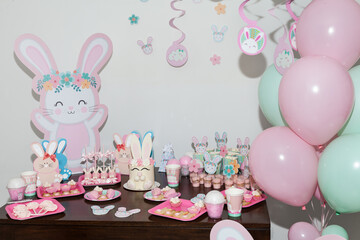 Thematic decoration for parties; Baby Shower - Table decorated with: Cakes, sweets, paper rabbits, and balloons.