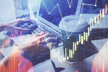 Double exposure of woman hands typing on computer and forex chart hologram drawing. Stock market invest concept.