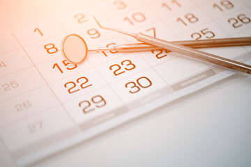 Calendar and dental instruments close-up. Dental health and teeth care concept