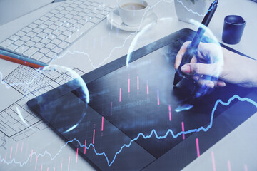 Double exposure of financial graph sketch hologram and woman holding and using a mobile device. Stock exchange concept.