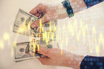 Multi exposure of financial graph drawing hologram and USA dollars bills and man hands. Analysis concept.