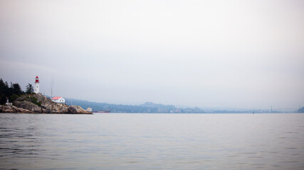 View of the Historic Lighthouse Point Park in West Vancouver off Point Atkinson, British Columbia, Canada with Lions Gate Bridge in the background