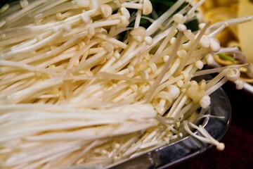 Fresh Enoki Enokitake Flammulina mushroom in a plate close up