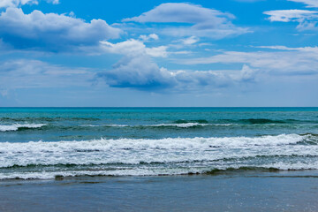 waves on the beach against the cloudy sky, use as a backdrop