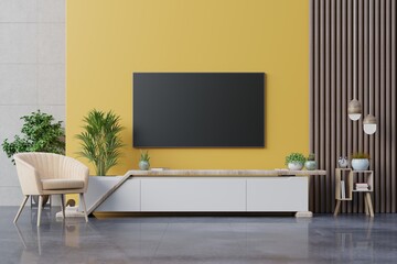 Living room led tv on yellow wall with armchair and cabinet tv on yellow wall background.