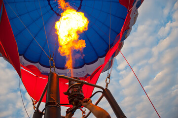 Gas burner and a jet of burning gas in a balloon.