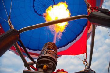 Gas burner and a jet of burning gas in a balloon.