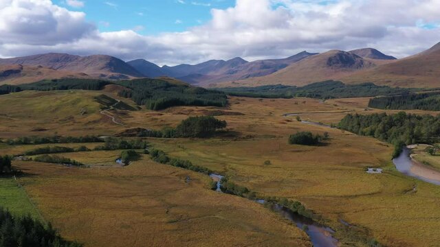 aerial drone image of loch tulla in the argyll region of the highlands of scotland during autumn on a clear bright day showing calm waters on the inland loch