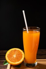 Fresh orange fruit and juice on wood background.