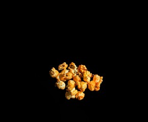 Popcorn with cheese on black background, cinema concept