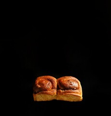 Cinnamon bread with chocolate on black background, pastry concept