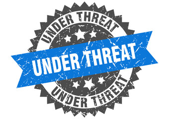 under threat stamp. grunge round sign with ribbon