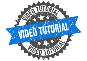 video tutorial stamp. grunge round sign with ribbon